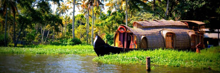 Hausbboot in den Backwaters in Kerala Indische Hausboote, so genannte Kettuvallams, sind umgebaute Boote, die früher zum Transport von Reis genutzt wurden.