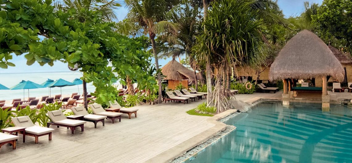 Sonnenliegen am Pool unweit des Strandes des Novotel Bali Benoa Resorts