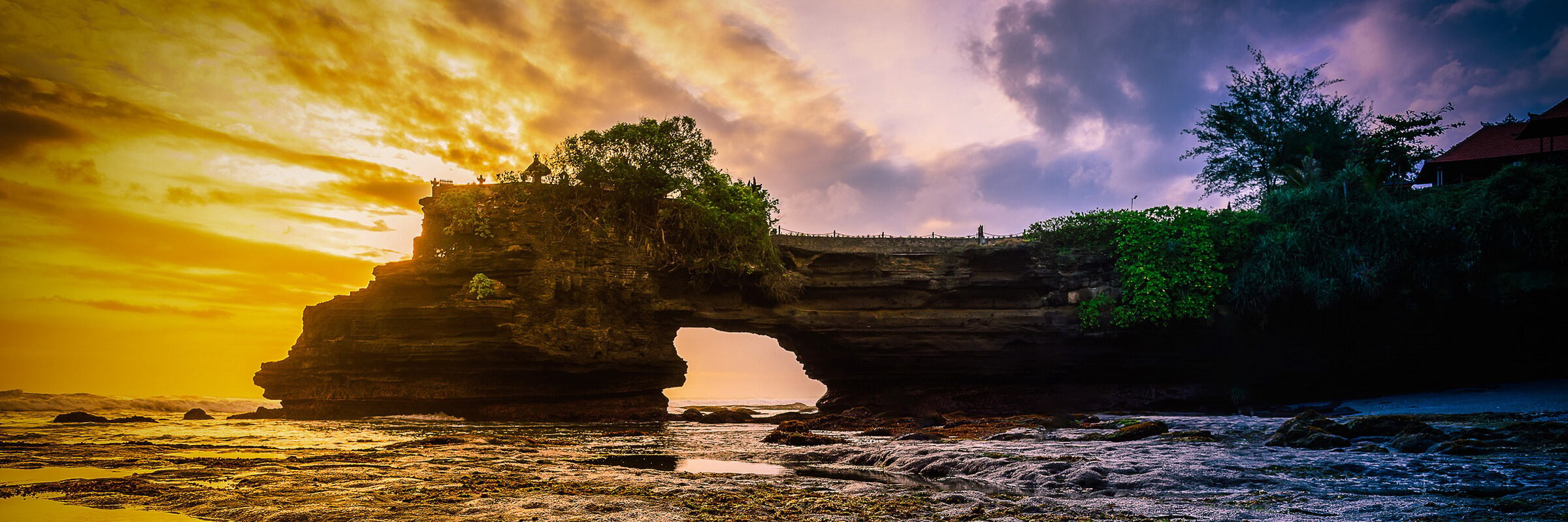 Auf dem Fußweg ist der „Meerestempel“ Pura Tanah Lot nur bei Ebbe über einen 50 m langen Gang über rundgewaschene Steine zu erreichen.