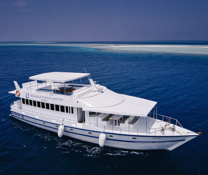 Das weiße Tauchsafari-Schiff Horizon II fährt auf dem tiefblauen Meer der Malediven.