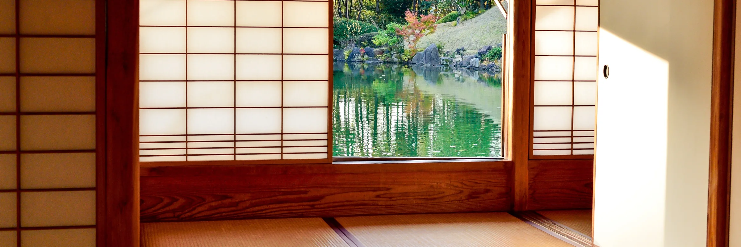 Traditioneller japanischer Raum (Washitsu) mit Blick auf einen Teichgarten
